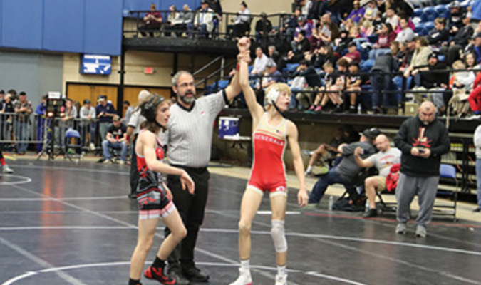 Lee’s John Carter is shown with a victorious raising of the hand during the VHSL state wrestling tournament in Salem.