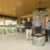 Mike Twigg, Jimmy Woodard and Wayne Nickodam gather near the fire pit at the new outdoor area at Cedar Hill Country Club with the covered, 900 square foot addition part of improvements at the recreation center.